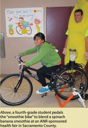 Above, a fourth-grade student pedals the “smoothie bike” to blend a spinach banana smoothie at an ANR-sponsored health fair in Sacramento County.